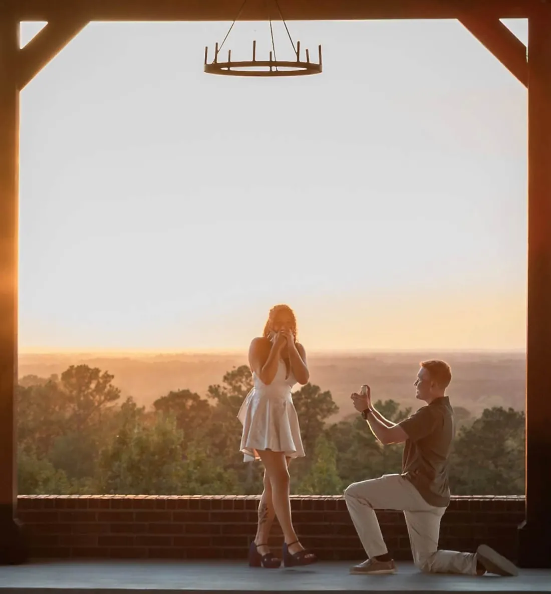 A real proposal at sunset beneath The Tower pavilion